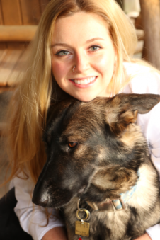 TUVAA president, Emily Dae Andersen, hugging a shepherd dog
